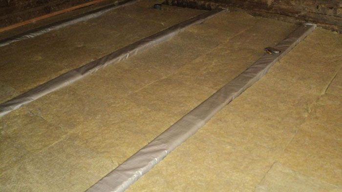 Laying mineral wool between floor joists