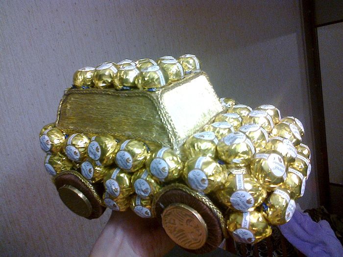 Round candies are glued onto a cardboard base