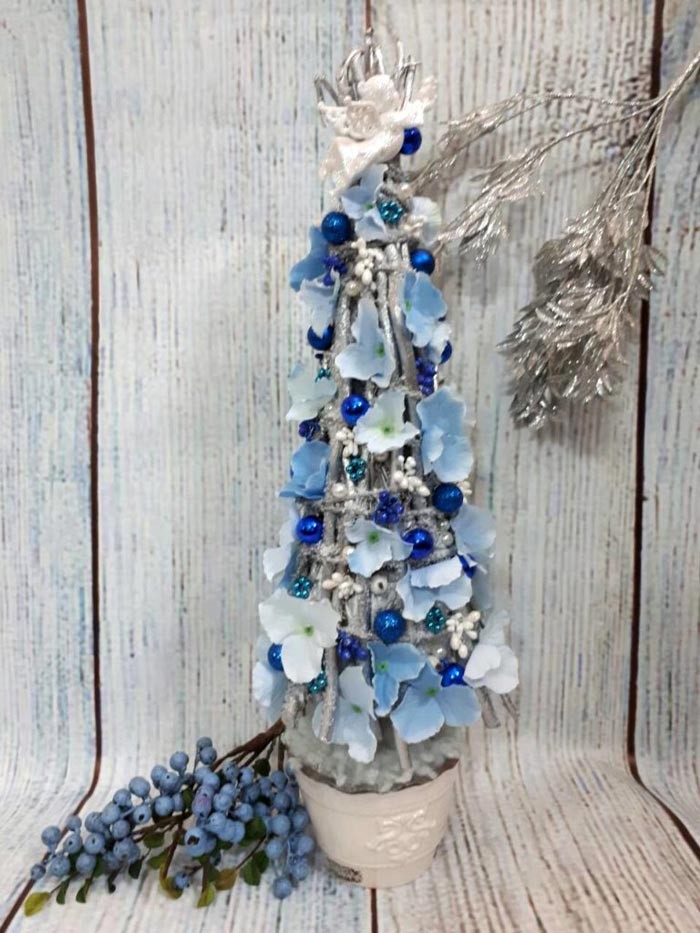 Decorative Christmas trees are made from cotton pads, cones, paper, thread and other material