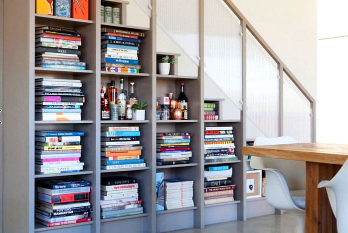 Sometimes the expression of a book under the stairs means that they are literally under it.