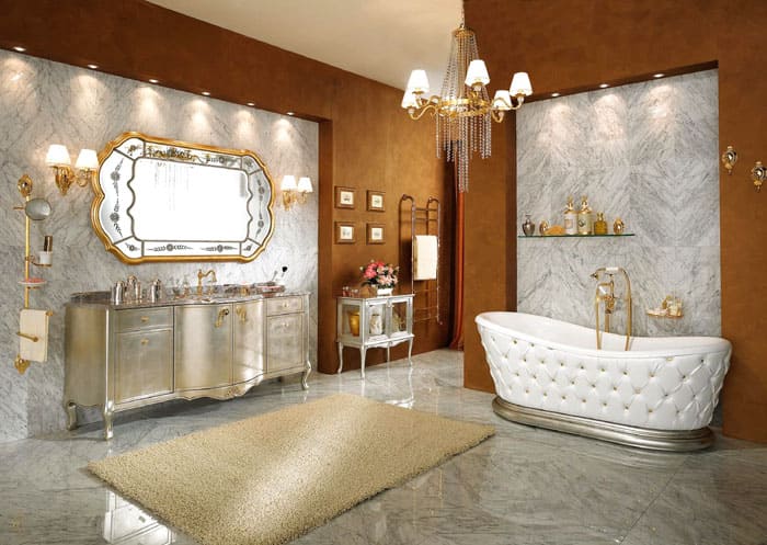 The marble finish in the photo goes well with the smooth outlines of the furniture. The bathtub looks unusual and its outer walls resemble the headboard upholstery